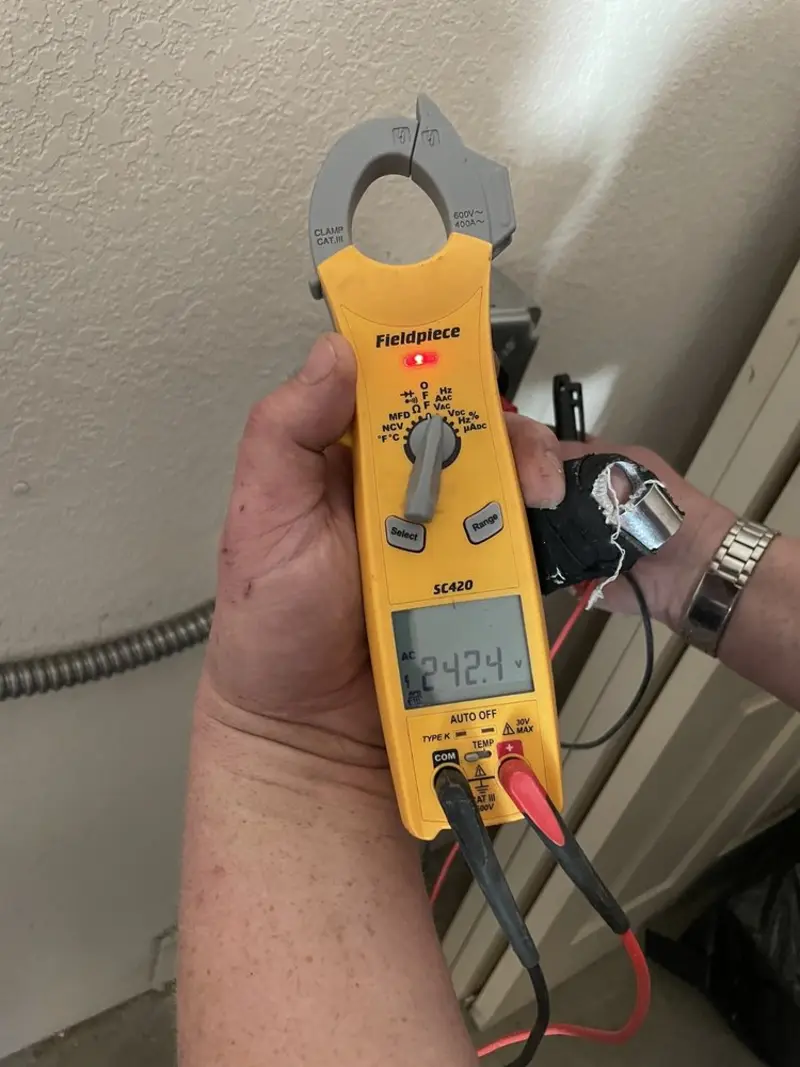 Voltage testing with clamp meter during Recessed Lighting Installation in Roswell